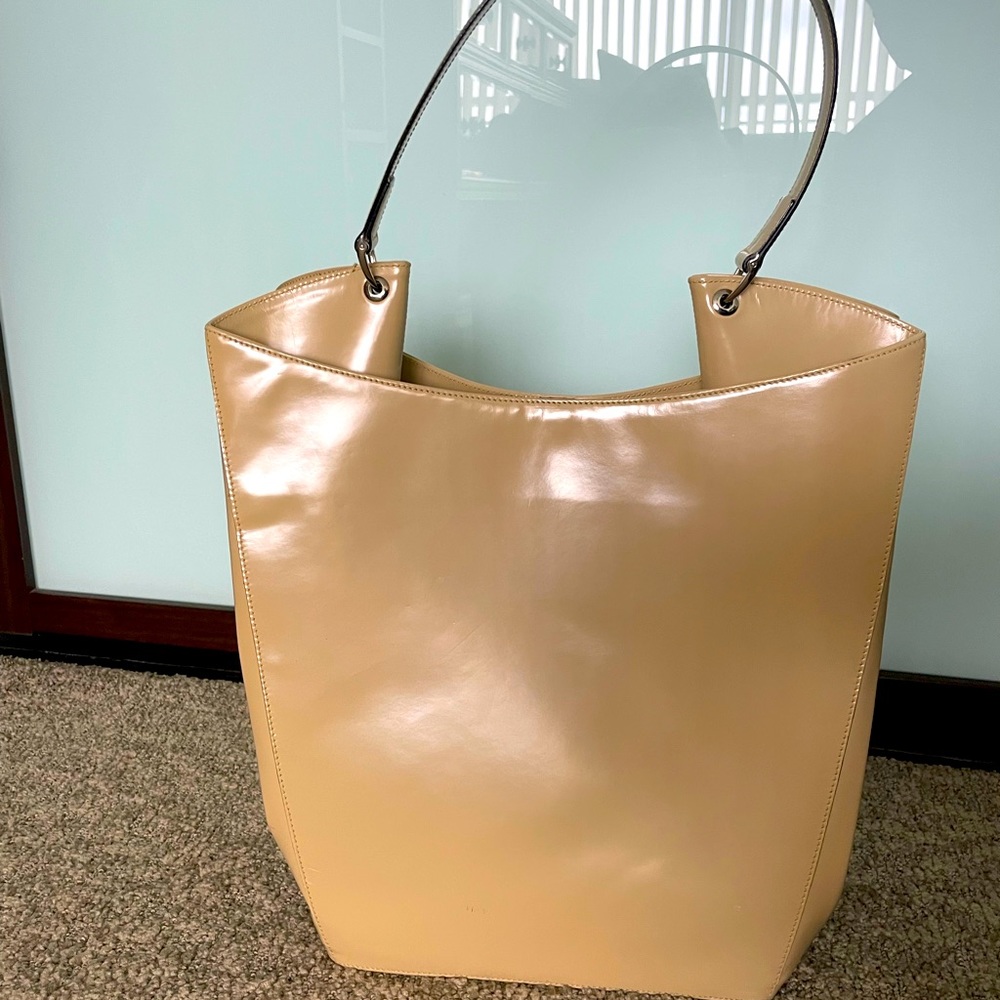 Suarez tan patent leather tall shoulder bag.